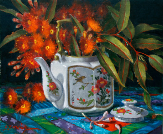 A china teapot full of flowers.